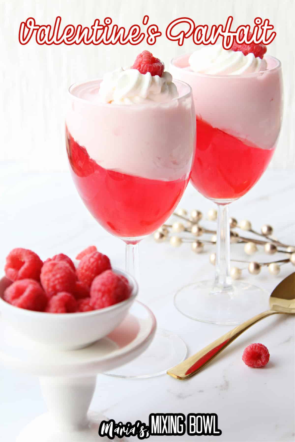 valentine's day parfait in a wine glass topped with a raspberry with the name in text for pinterest