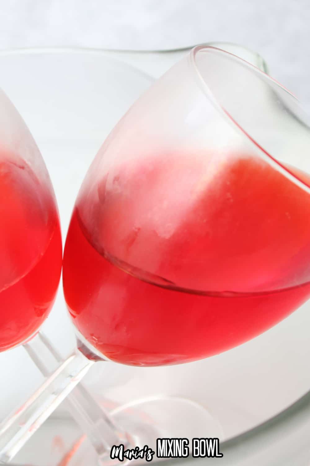 jello in a wine glass in a glass mixing bowl