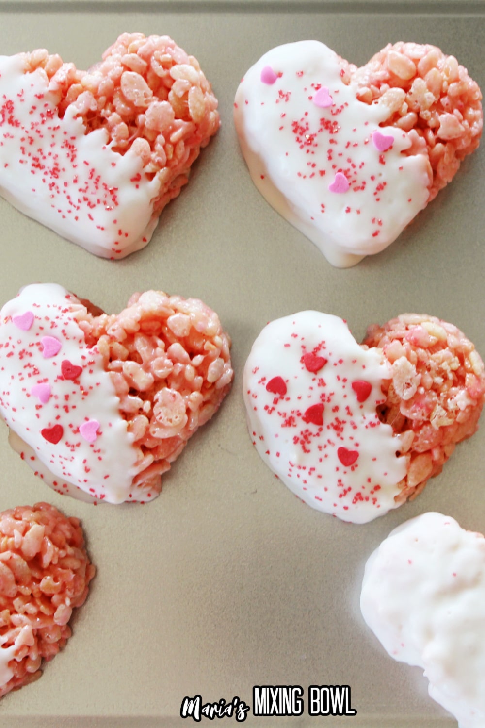 rice krispie treats dipped in white chocolate and topped with sprinkles