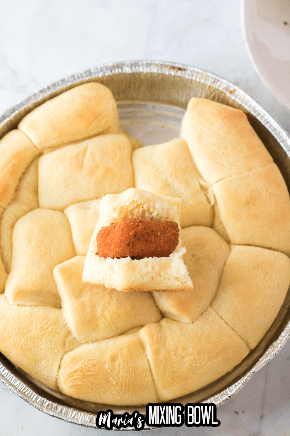 rolls being filled chicken nuggets