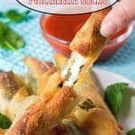 mozzarella stick broken in half and held in a woman's fingers