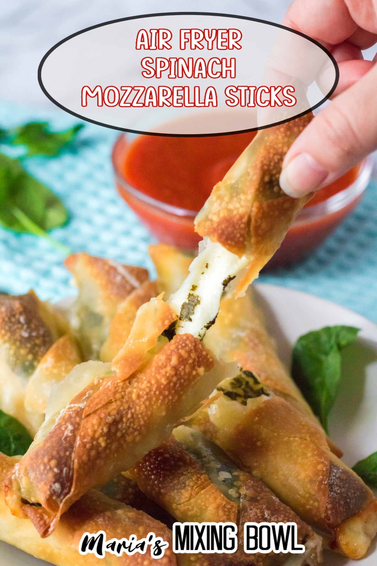 mozzarella stick broken in half and held in a woman's fingers