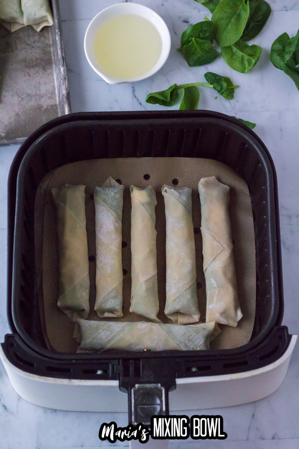 mozzarella sticks in an parchment lined air fryer basket