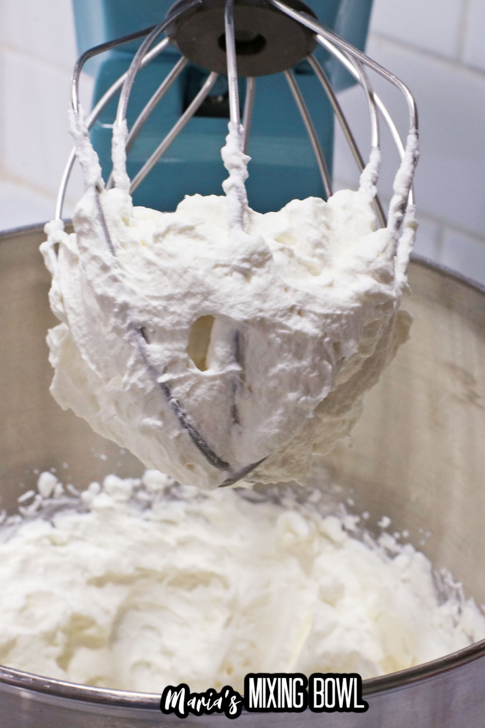 cream cheese and sugar being mixed in a stand mixer
