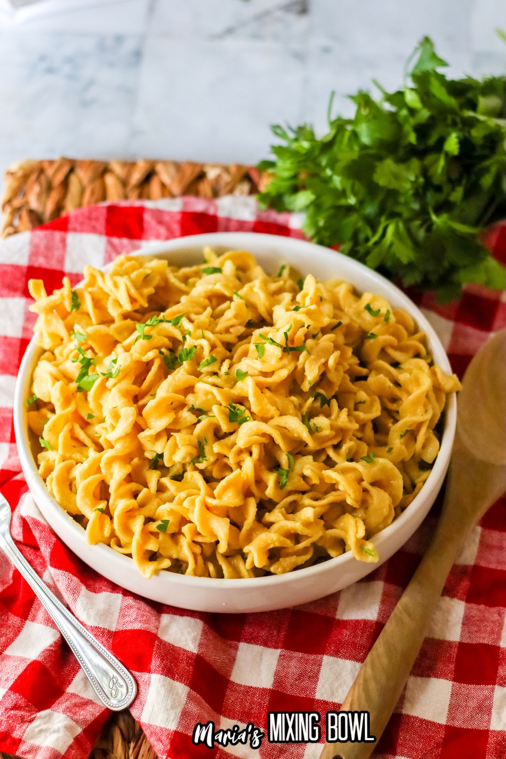 white bowl filled with cafeteria noodles and garnished with parsley