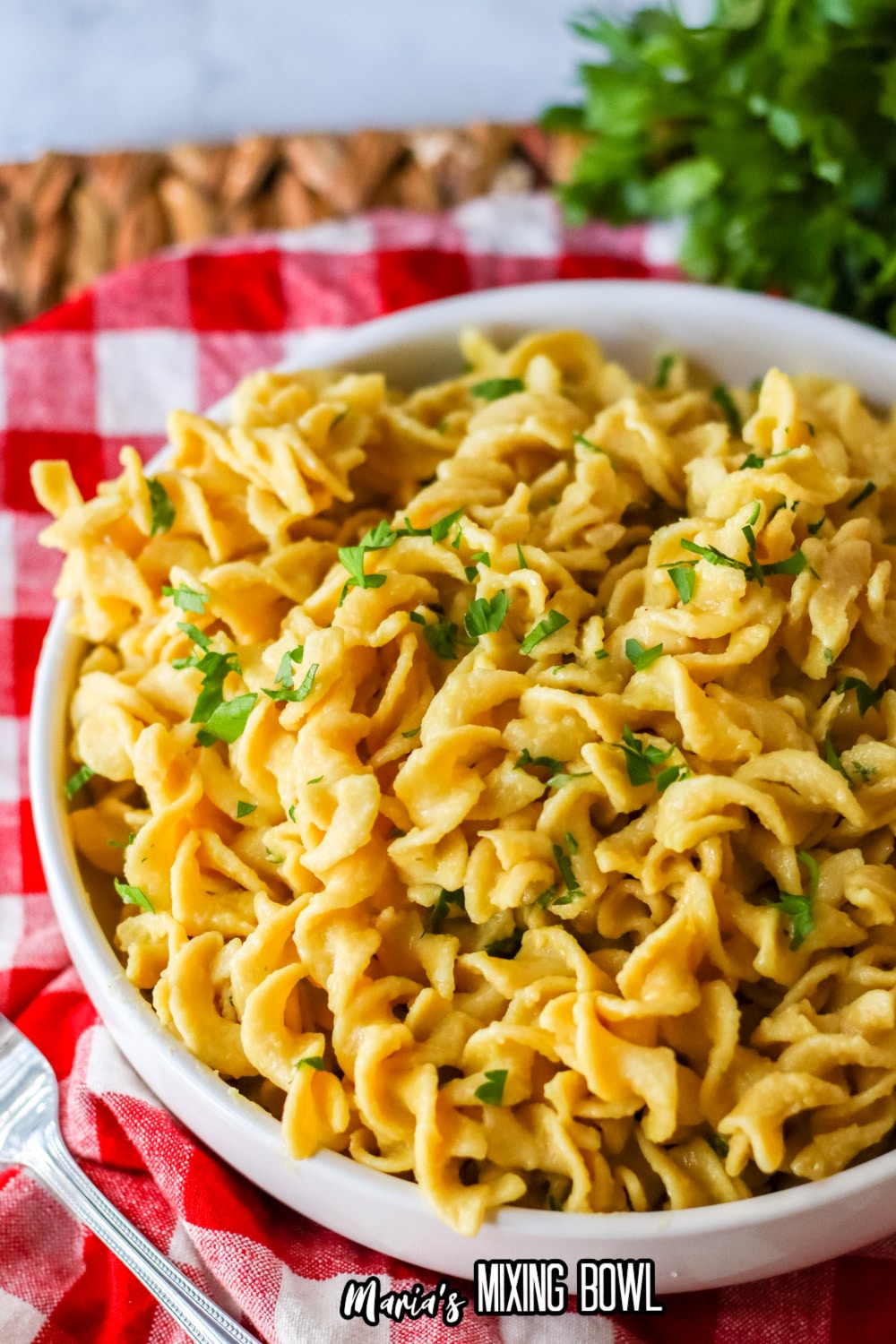 white bowl filled with cafeteria noodles and garnished with parsley