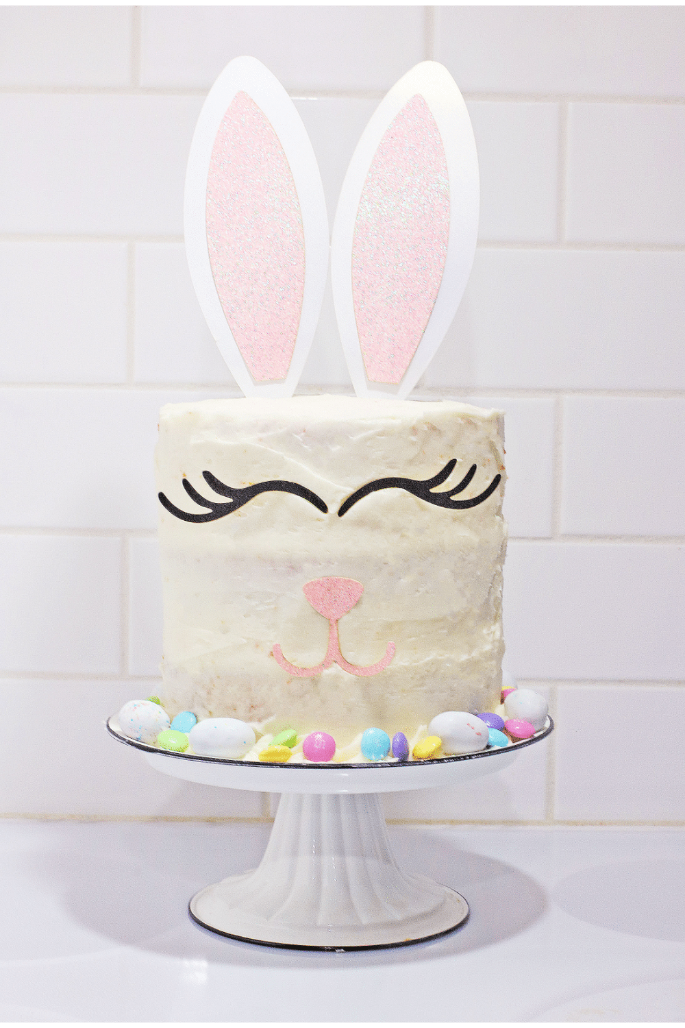 uncut bunny cake on a white cake stand