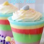 small plastic cups filled with colorful easter layered jello and topped with whipped cream with the name in text for pinterest