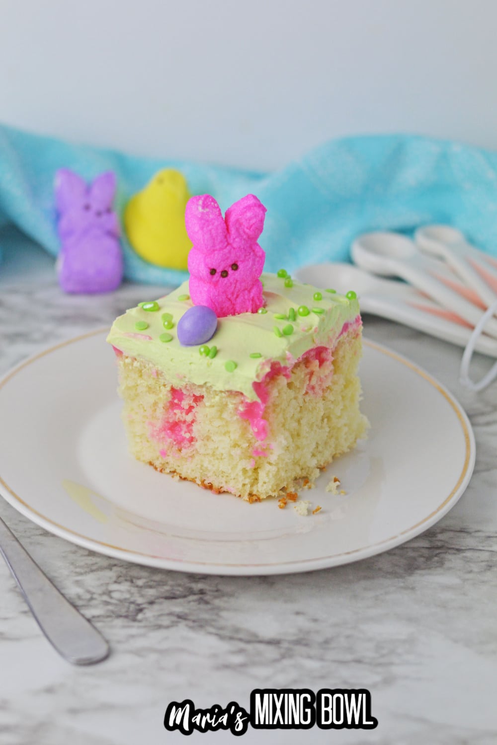 slice of easter poke cake on a white plate
