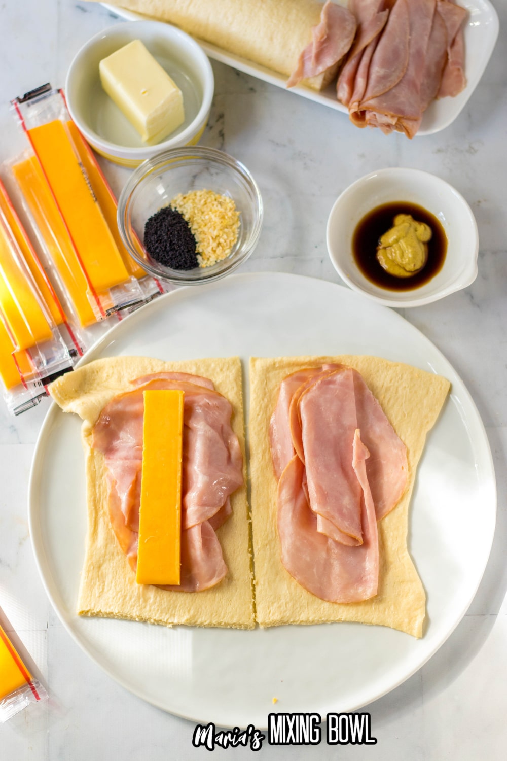 crescent rolls being filled with ham and cheese
