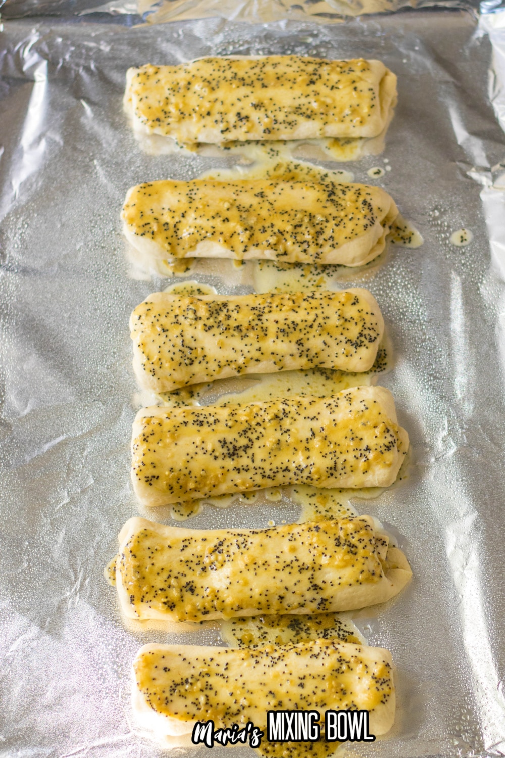 mustard and poppy seed sauce on top of stuffed cresecent rolls