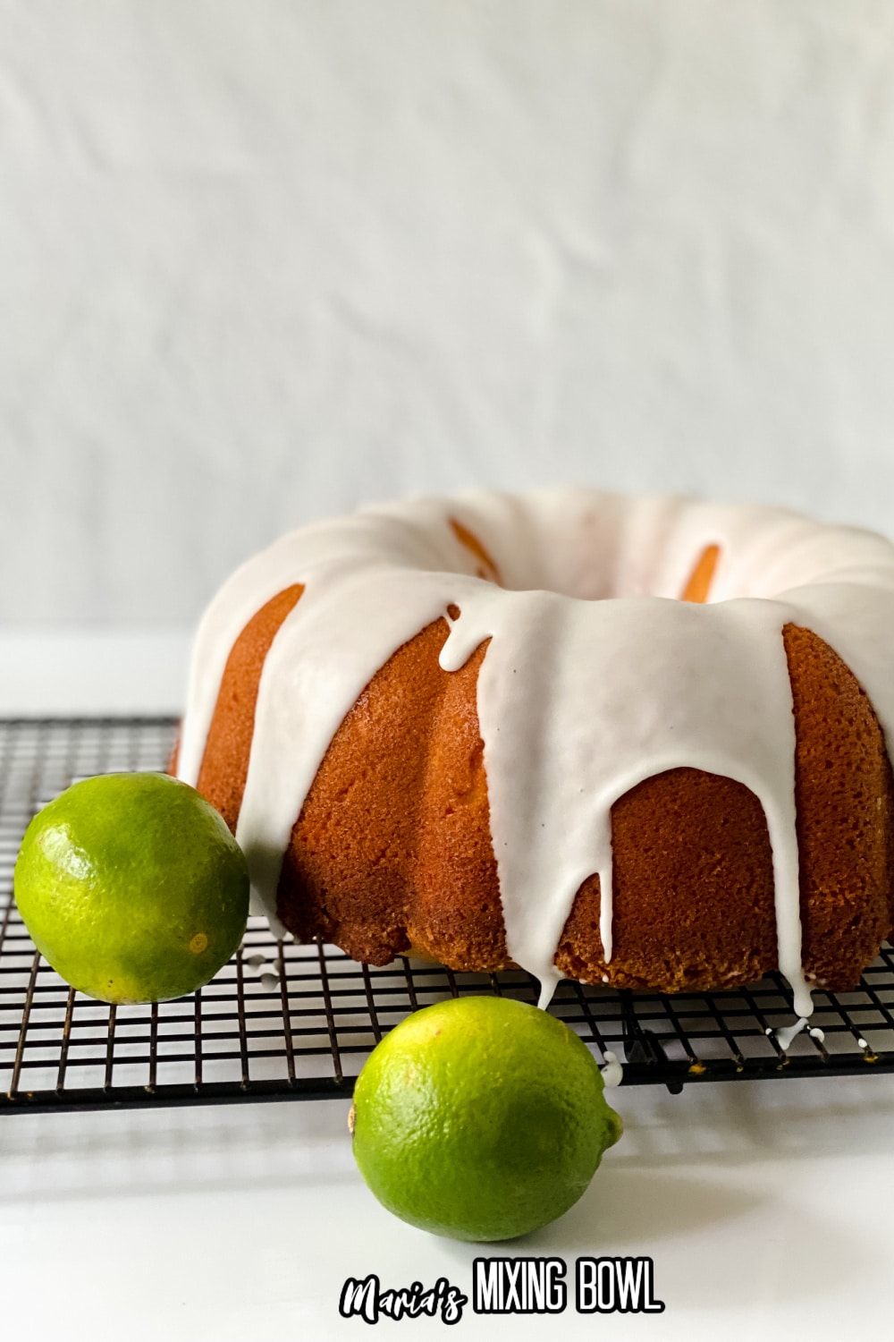 whole key lime pound cake on a wire cooling rack