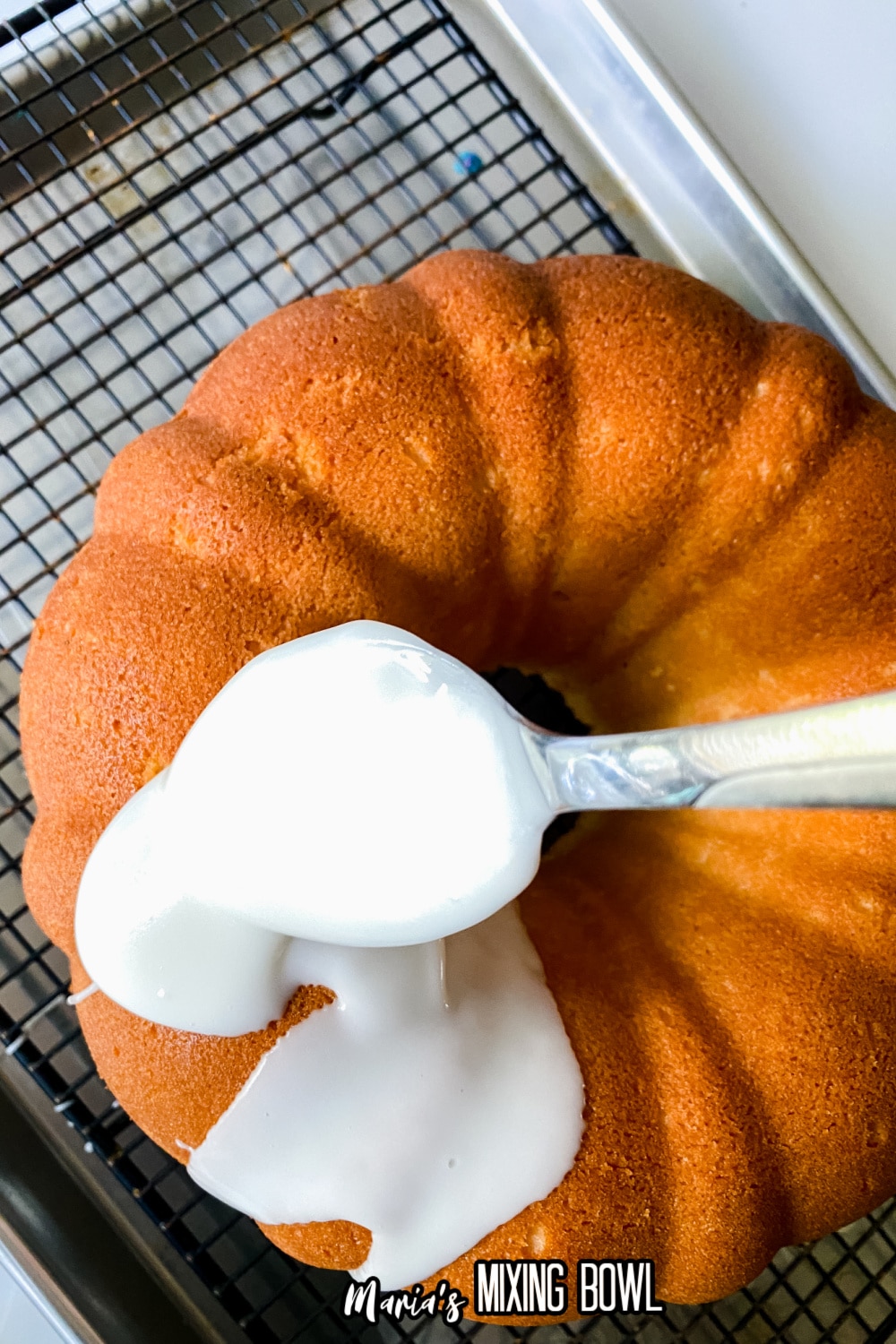 finished cake with a glaze being poured over it