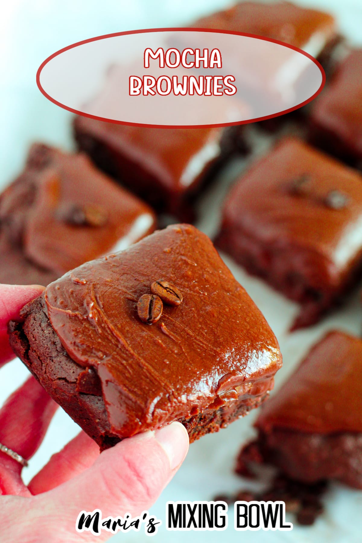 brownie held in the air by a woman's hand with the name in text for pinterest