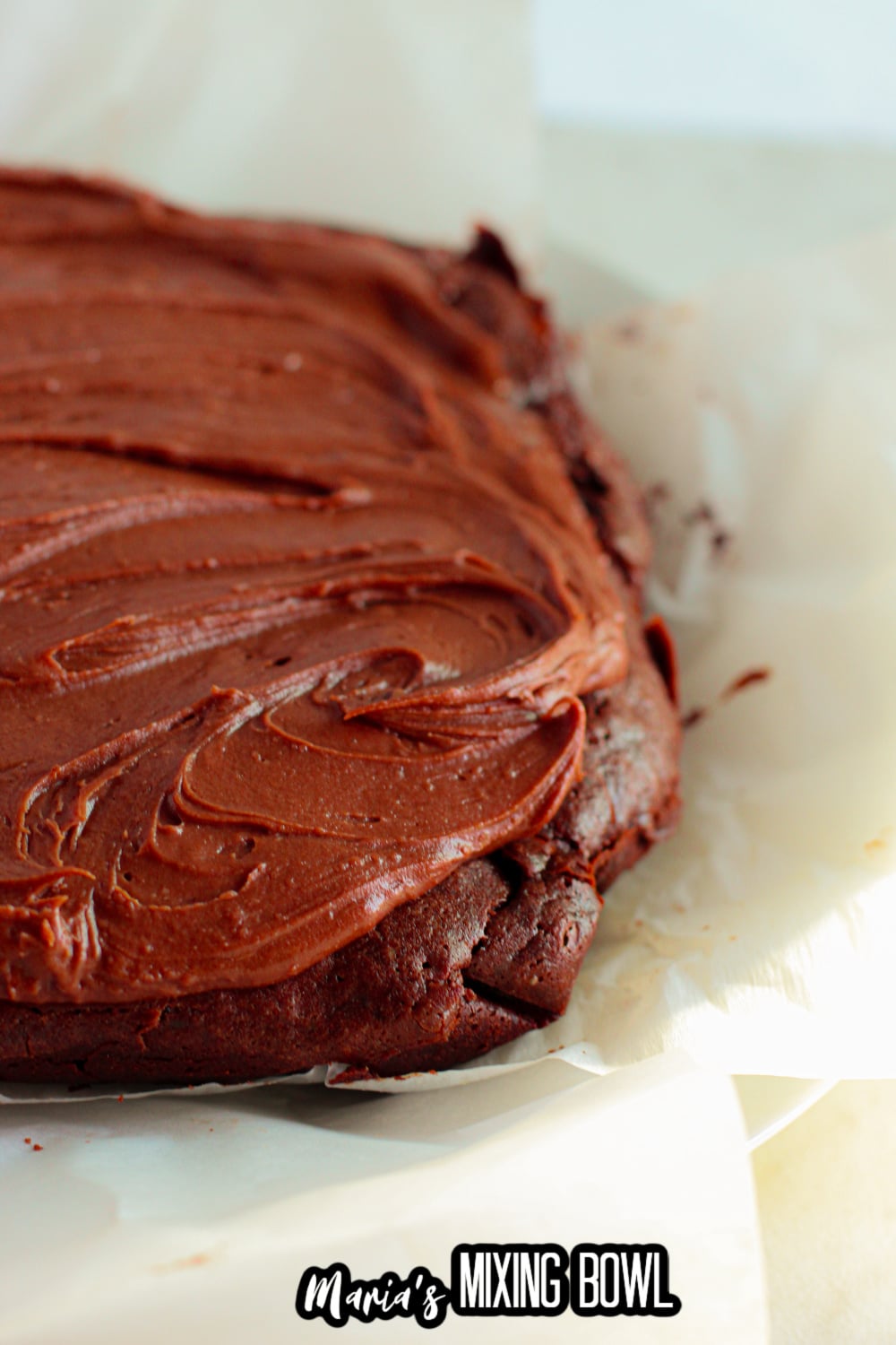 brownies being frosted with a chocolate frosting