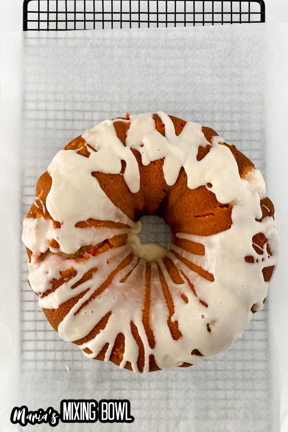 finished whole Neapolitan pound cake on a parchment lined cooling rack