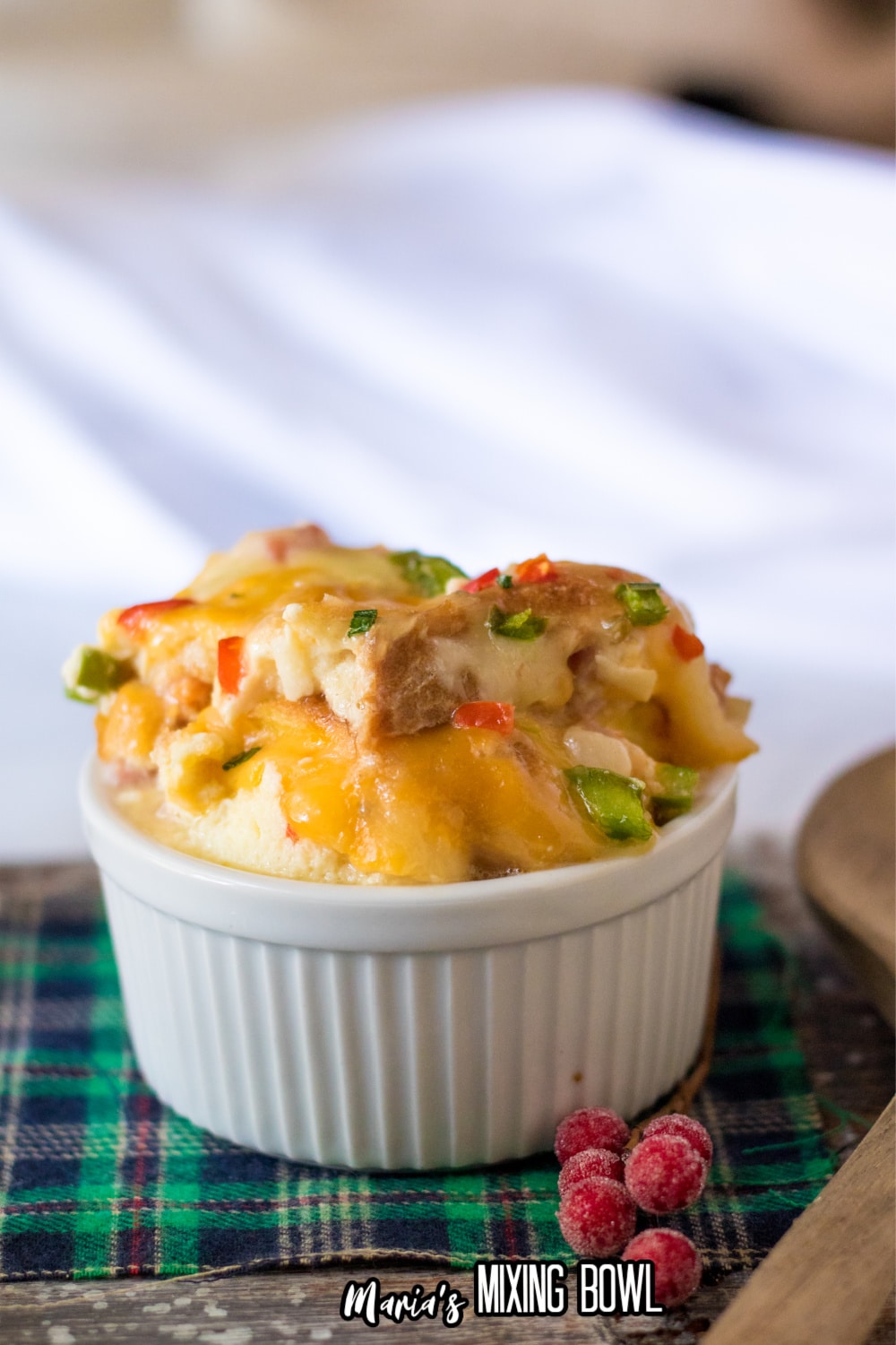 scoop of overnight egg casserole in a ceramic ramekin