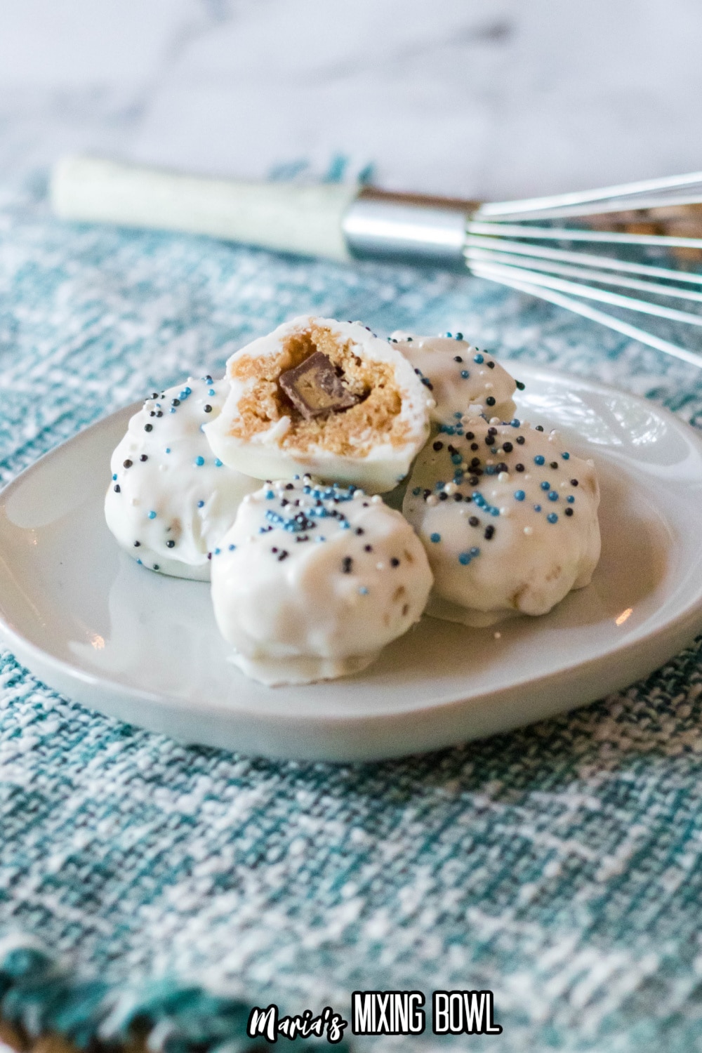 five peanut butter balls on a white plate