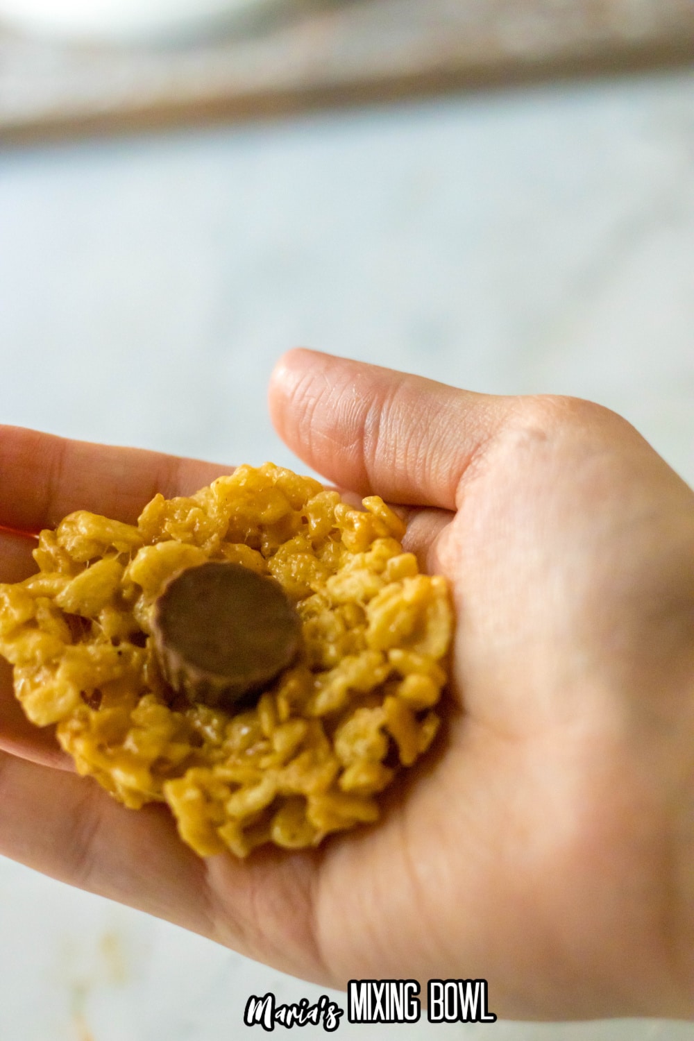rice krispies being stuffed with a peanut butter cup
