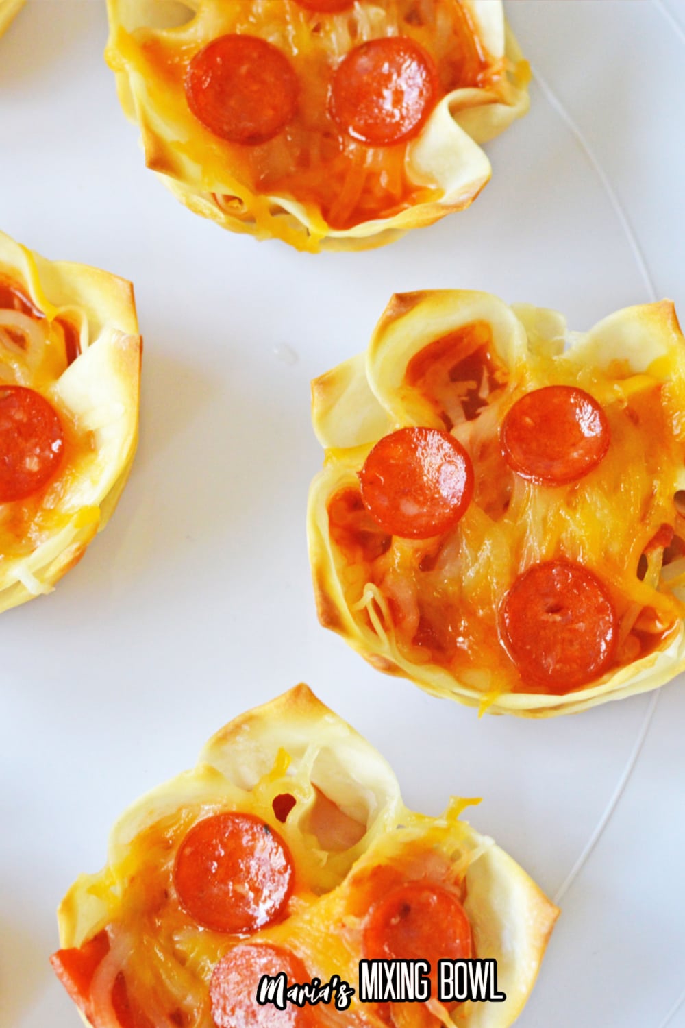 pizza wonton cups on a white plate