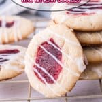 stack of raspberry cheesecake thumbprint cookies with one cookie on it's side leaning against the others