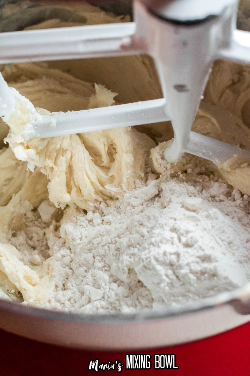 flour being added to butter and sugar in a stand mixer