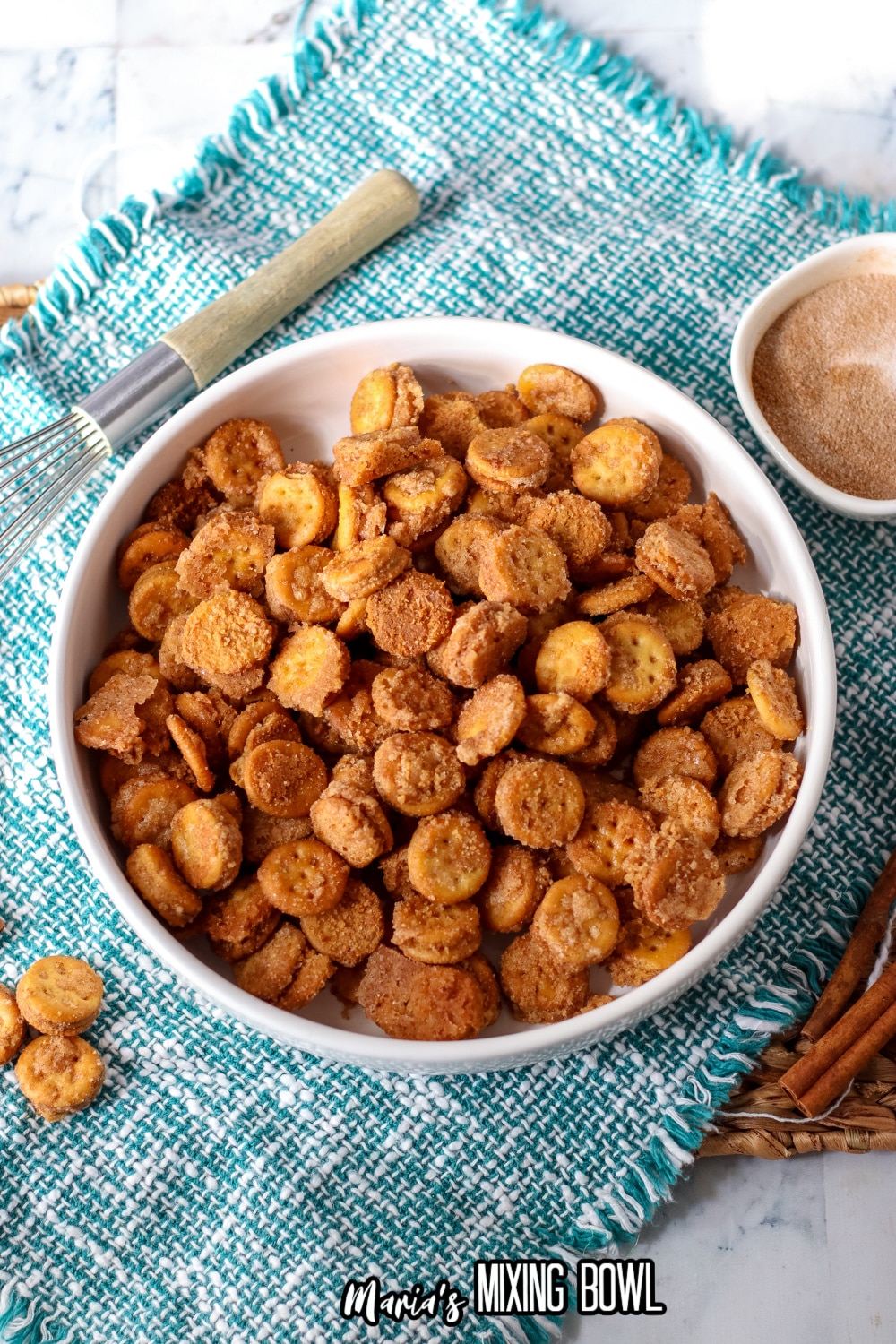 white bowl filled with ritz bitz churros on a teal and white placemat.