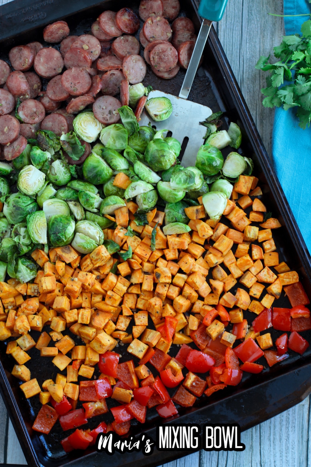 sausage, brussel sprouts, sweet potatoes and peppers on a sheet pan