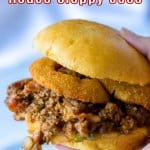 sloppy joe sandwich held in a woman's hand in the air with the name in text for pinterest