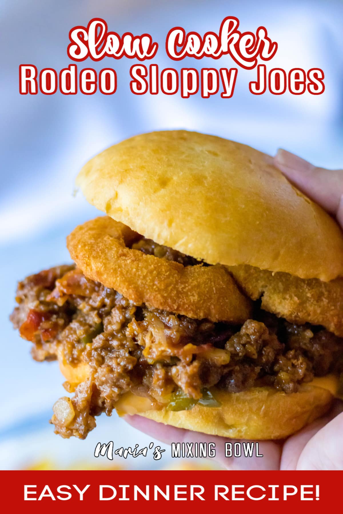 sloppy joe sandwich held in a woman's hand in the air with the name in text for pinterest