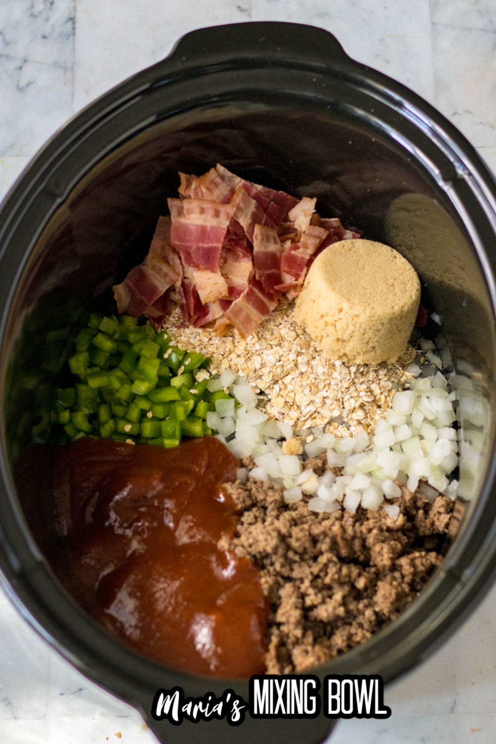 ground beef, sauce, peppers, onions, brown sugar and bacon in a slow cooker liner