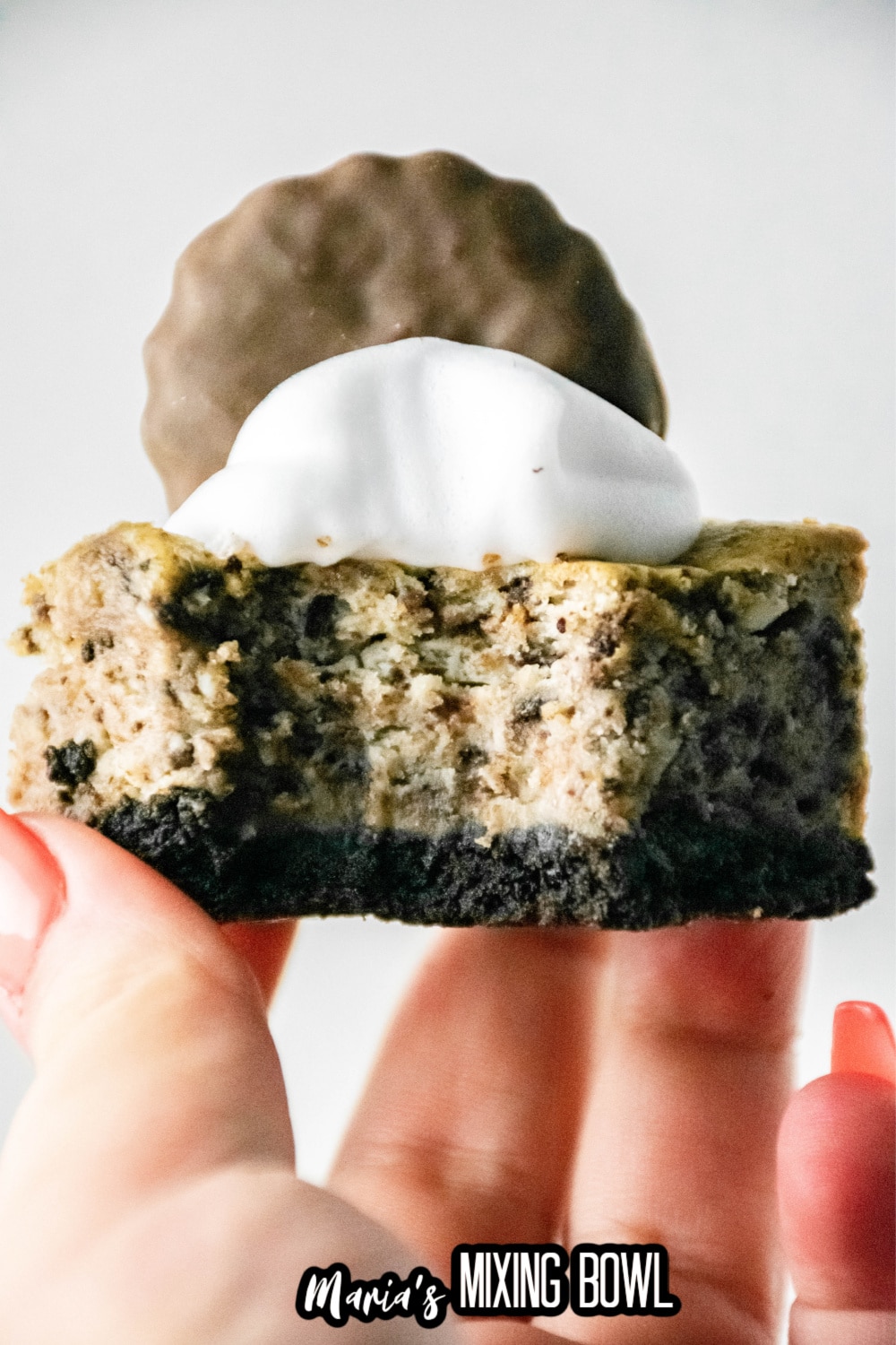 thin mint cheesecake bar held in a womens hand