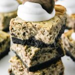 three thin mint cheesecake bars stacked on a white background