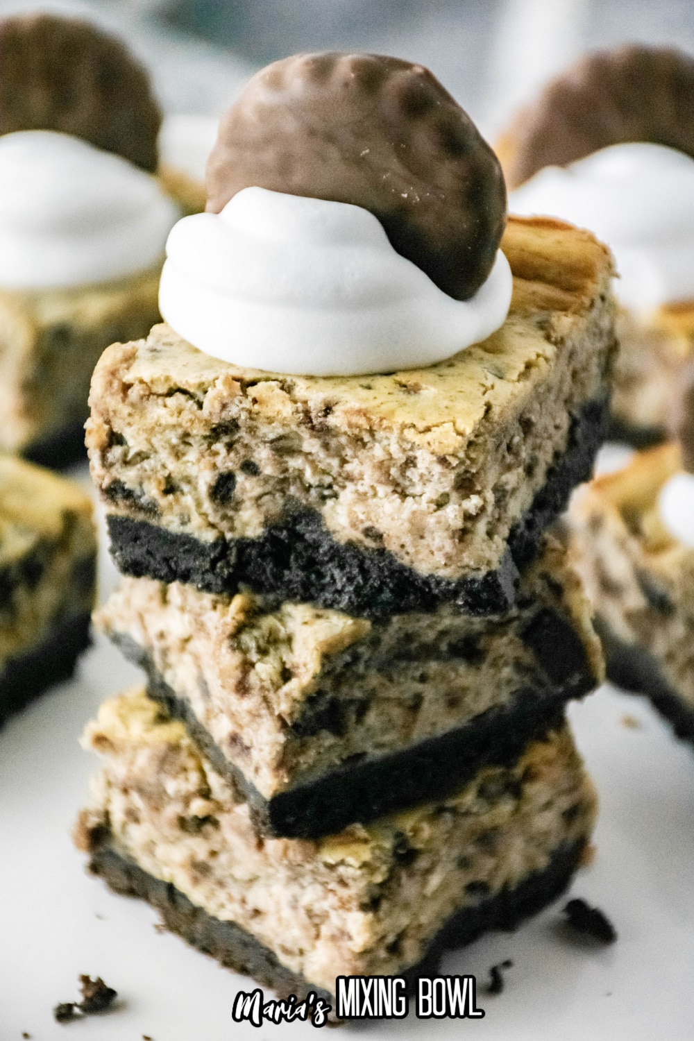 three thin mint cheesecake bars stacked on a white background
