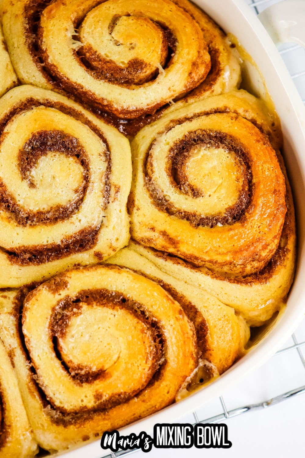 baked unfrosted cinnamon rolls in a white baking dish
