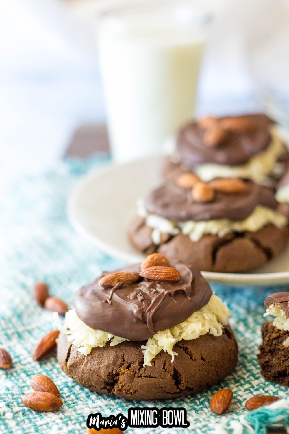 almond joy cookies on a white plate and teal and white napkin