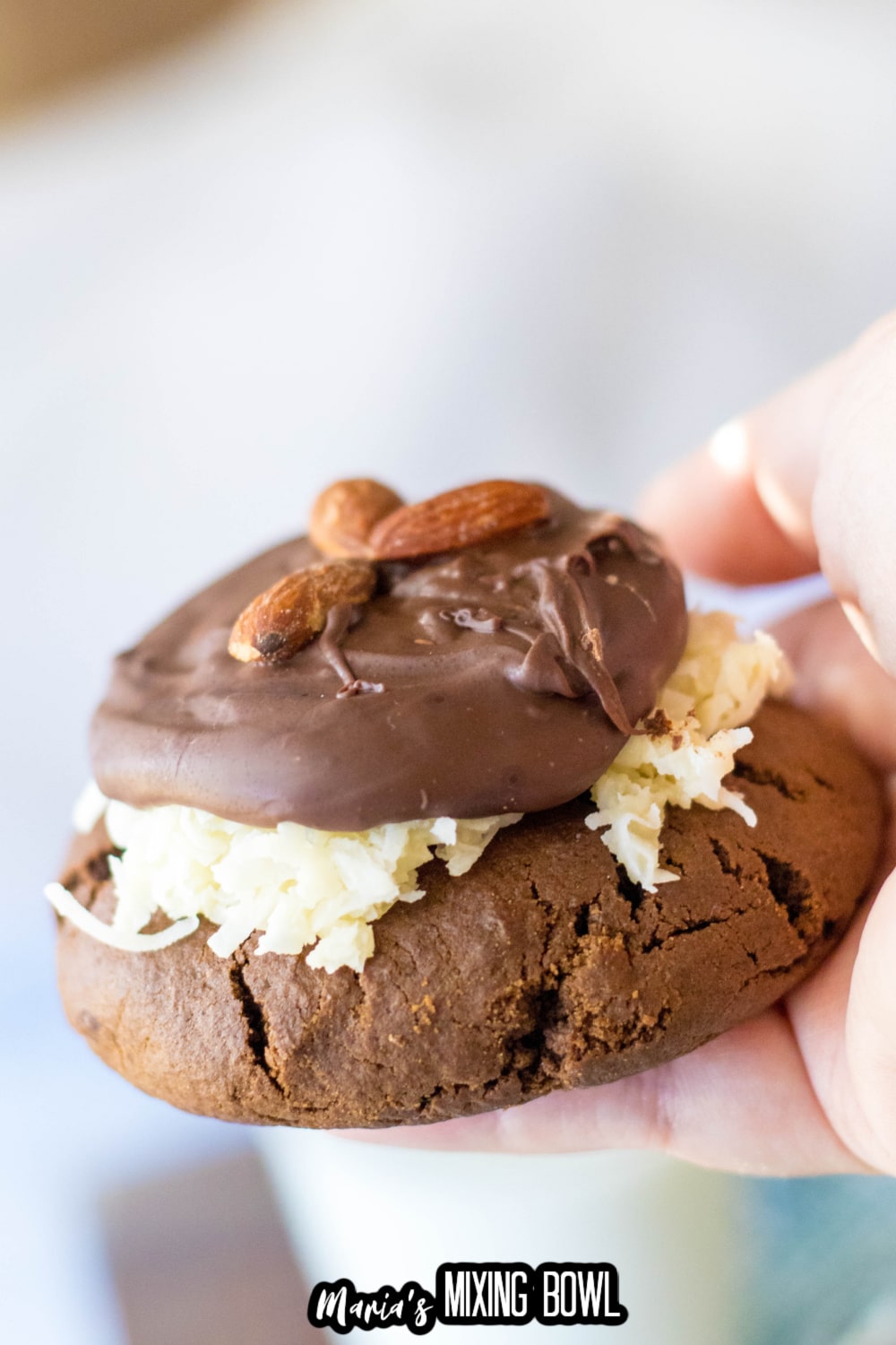 almond joy cookie held in a woman's hand