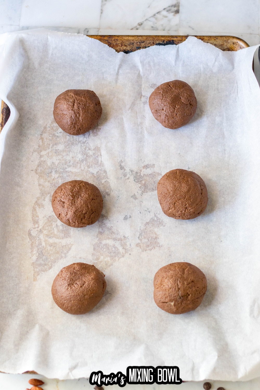 dough balls on a parchment lined baking sheet
