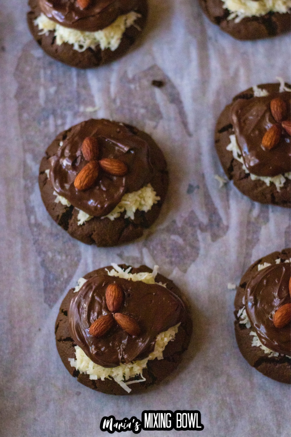 finished almond joy cookies on a parchment lined baking sheet