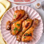 four bbq chicken legs on a light pink scalloped plate