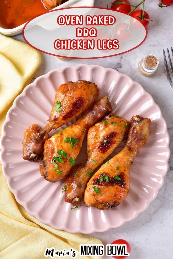 four bbq chicken legs on a light pink scalloped plate