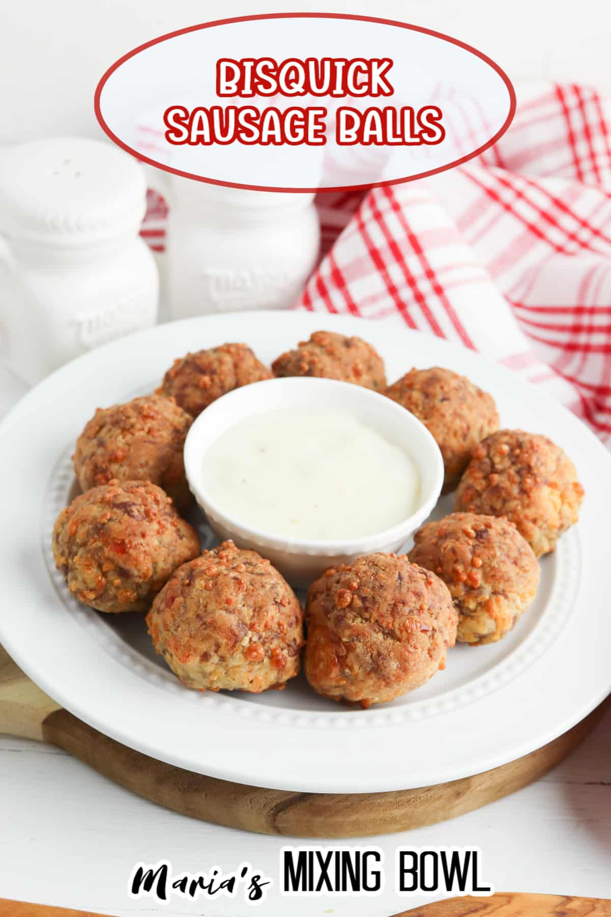 bisquick sausage balls on a white plate with a small bowl of gravy in the center