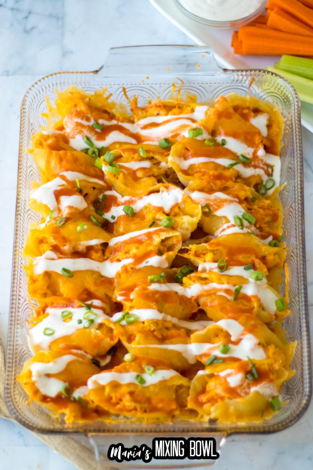 buffalo stuffed shells in a glass baking dish