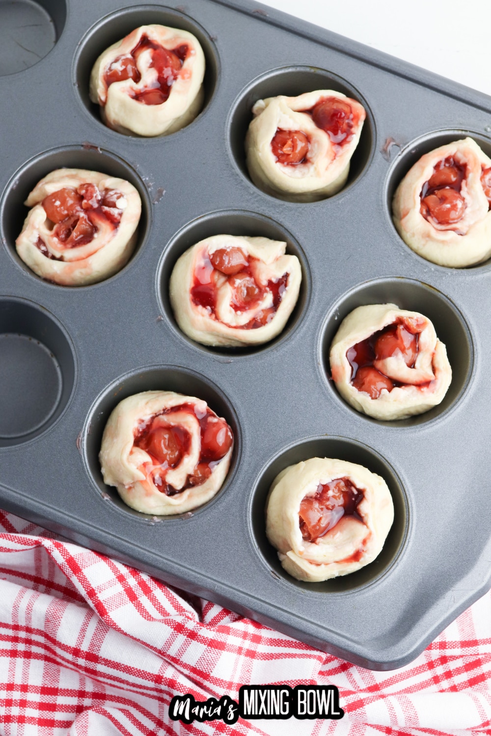 cherry muffins in a muffin tin