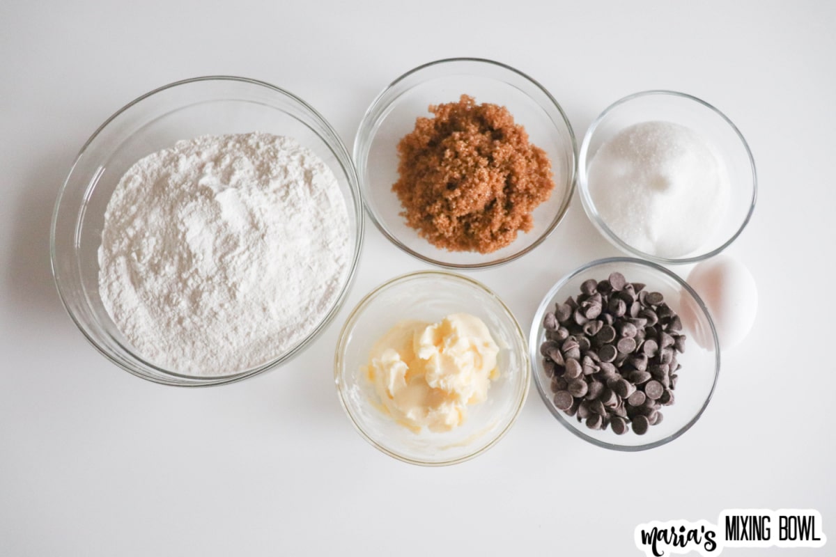 flour, brown sugar, sugar, butter, and chocolate chips in small glass bowls
