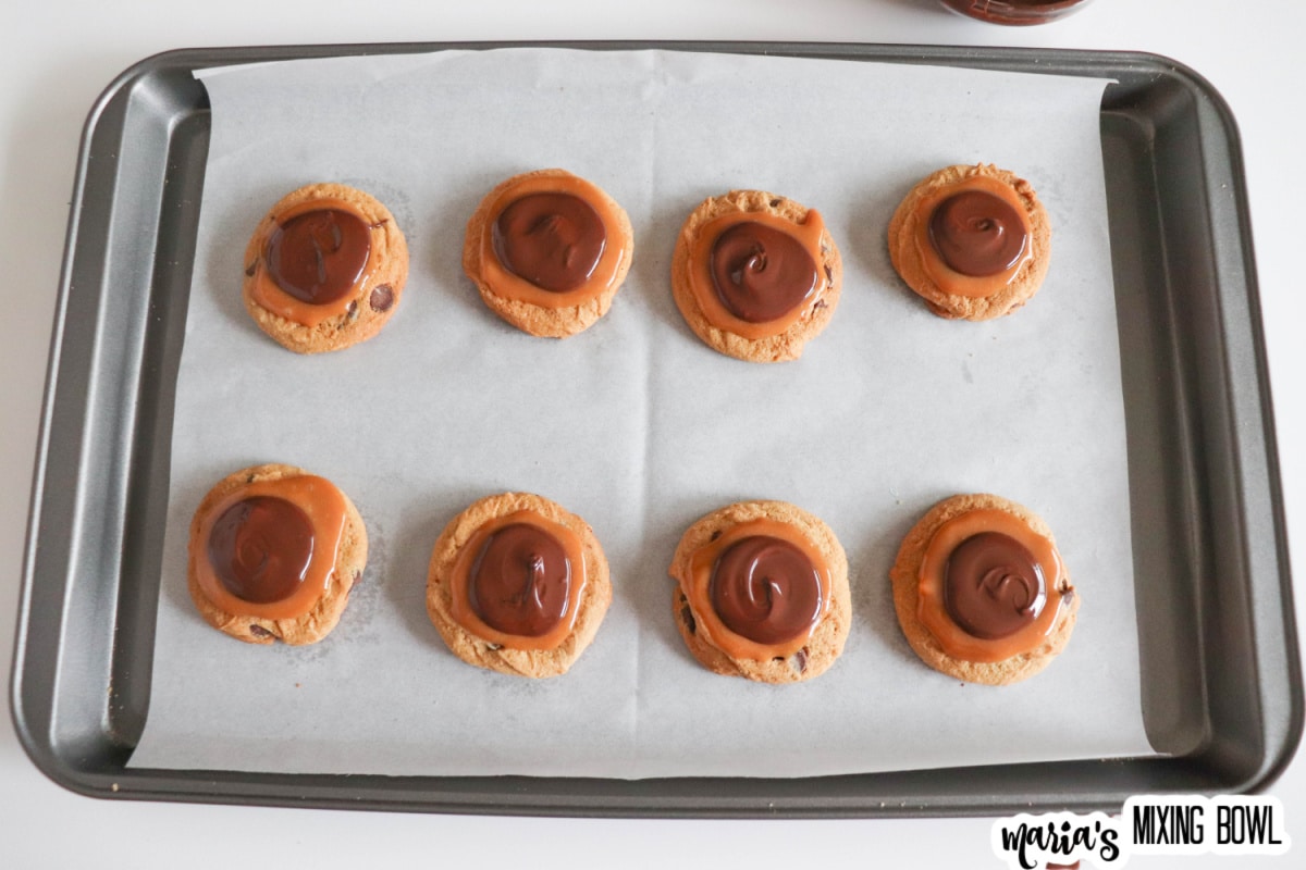 chocolate caramel cookies on a parchment lined baking sheet