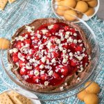 chocolate cheesecake dip with cherries on top in a pie plate
