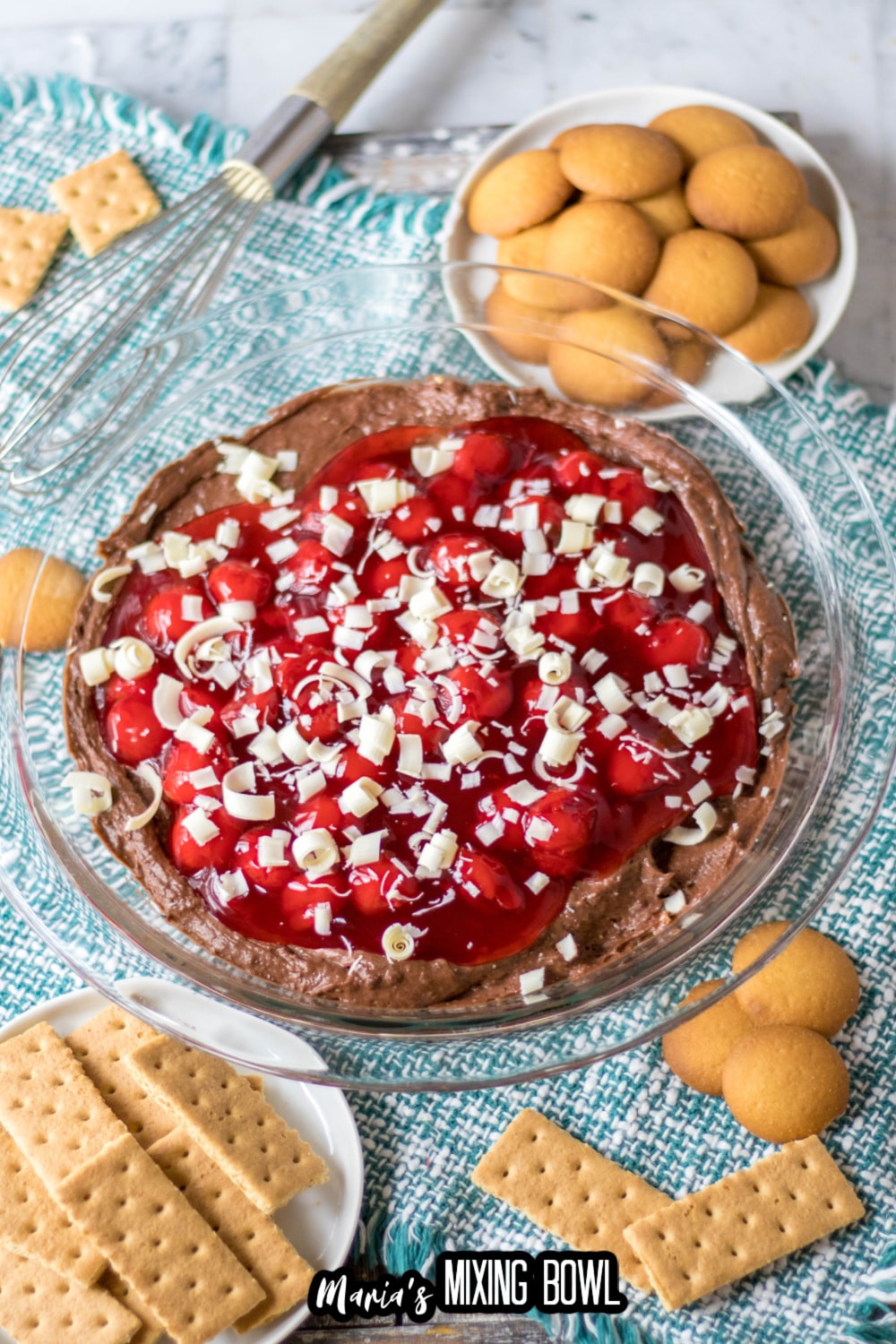 chocolate cheesecake dip with cherries on top in a pie plate