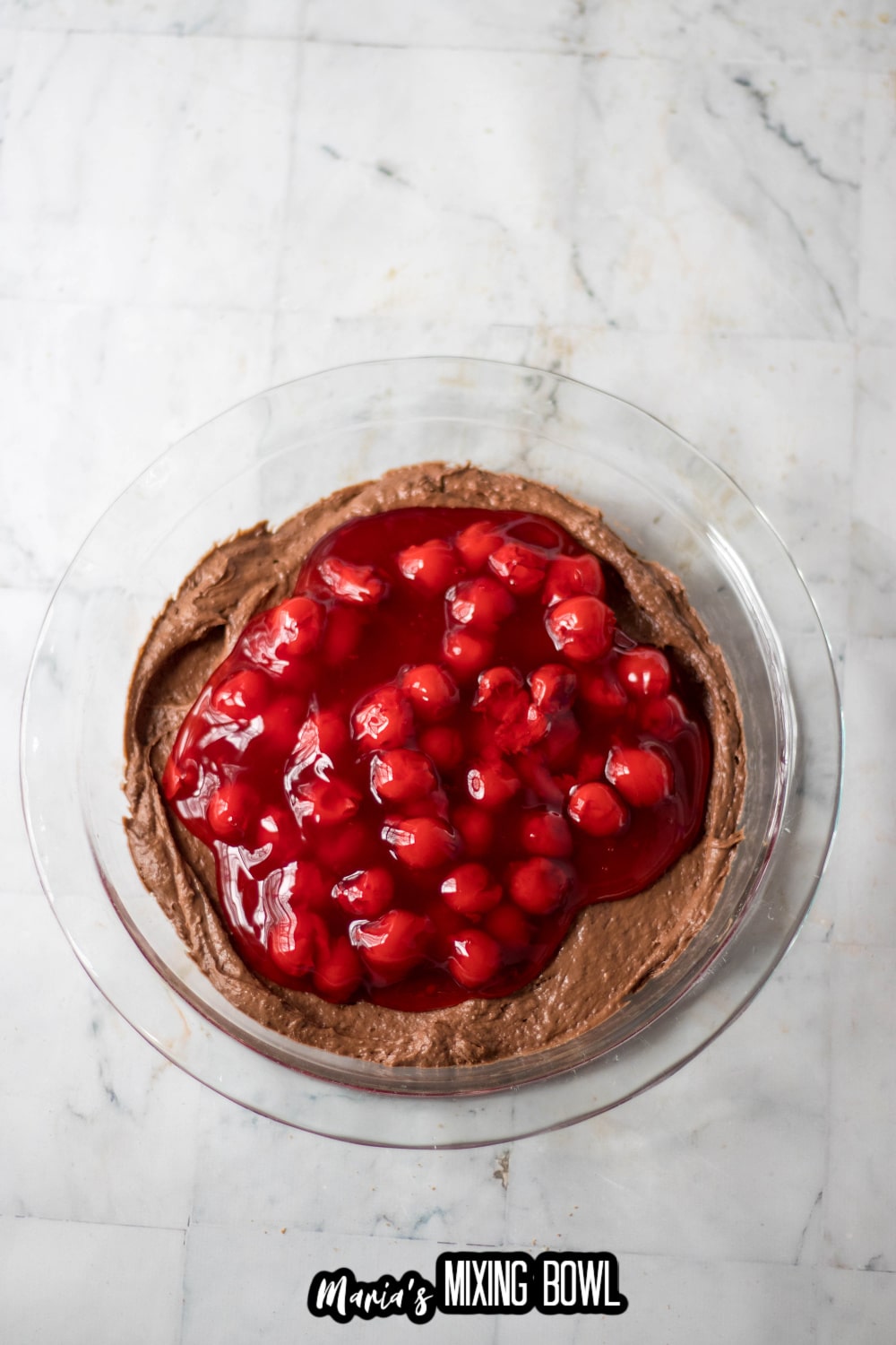cherries being poured onto of dip