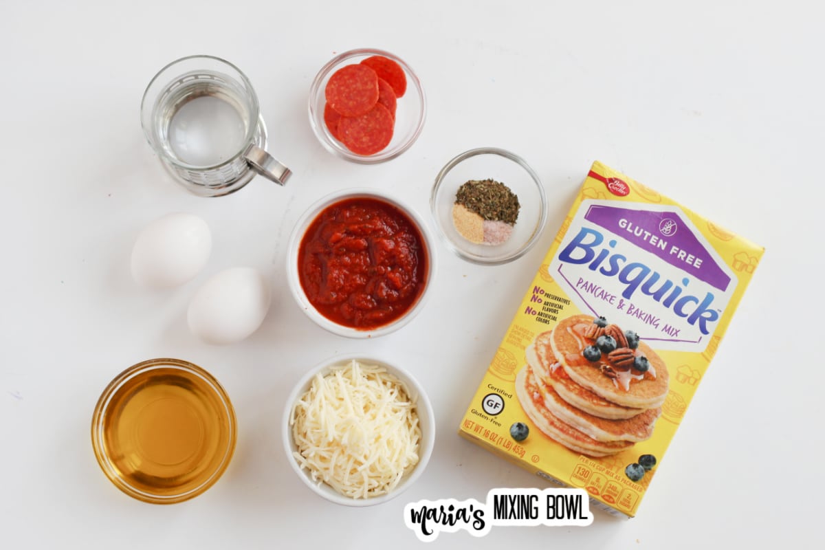 water, eggs, bisquick, oil, pizza sauce, mozzarella cheese, pepperoni, and seasonings on a white backdrop